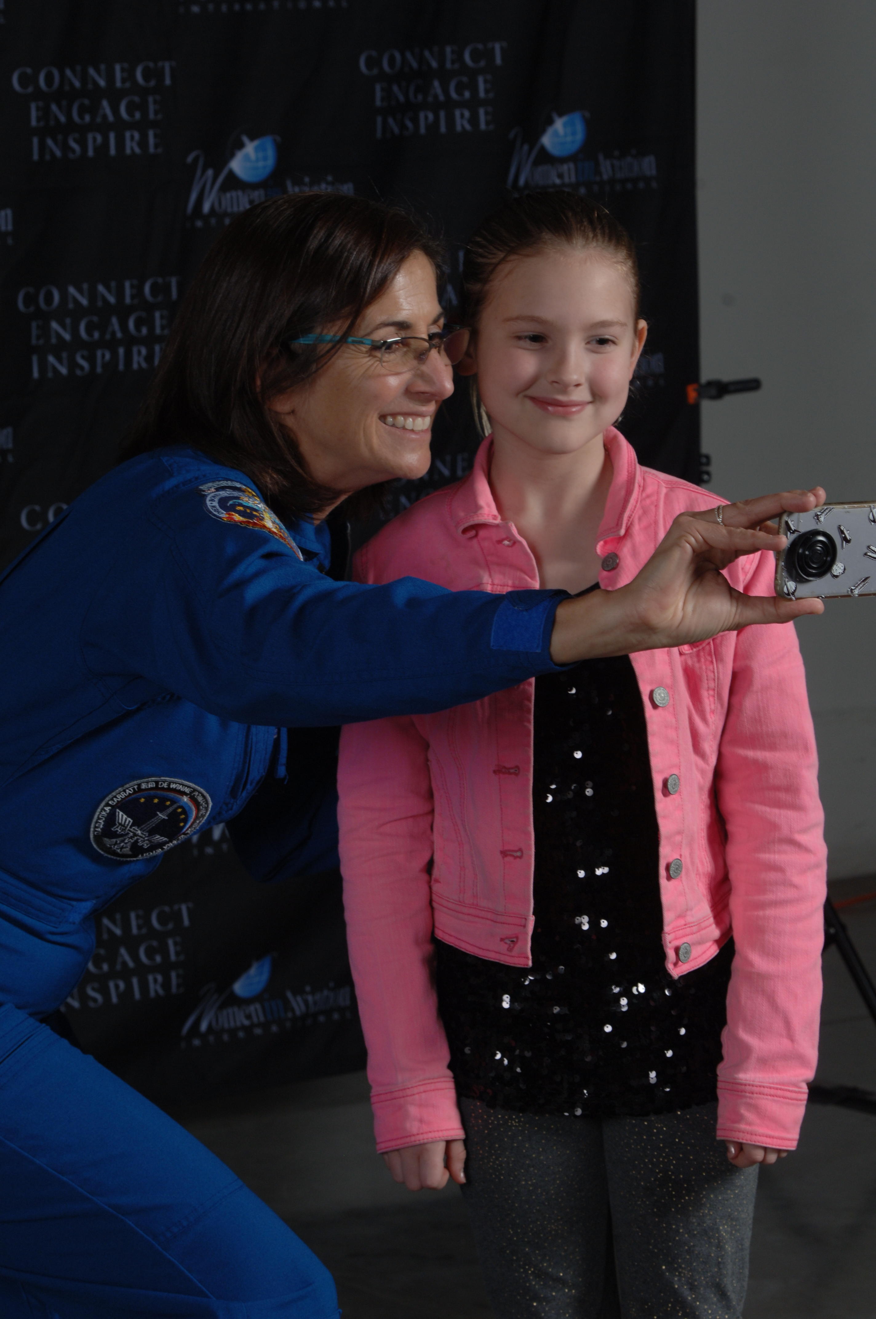 Astronaut Nicole Stott with girl taking selfie
